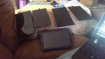 A collection of Android tablets laid out in cases.